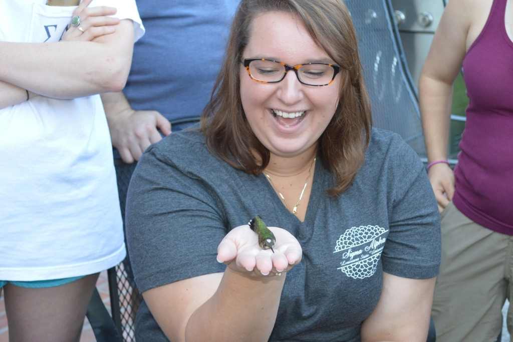 Student holding hummingbird