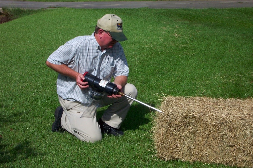 person takes hay sample