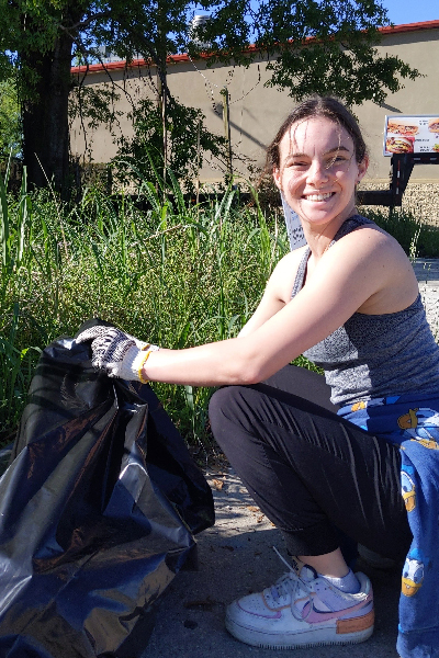 student cleaning up at geaux big event