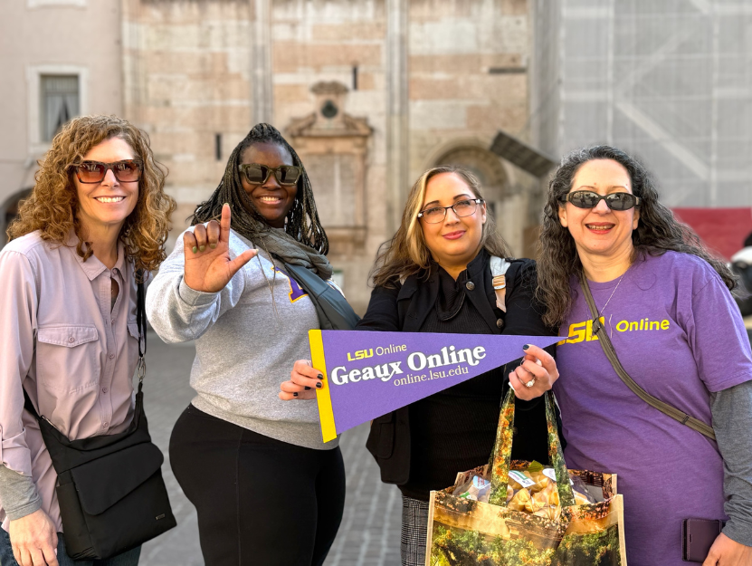 LSU Online Staff and Jessica WIlkes stand in LSU garb