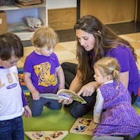 Student reads to children at the care center.