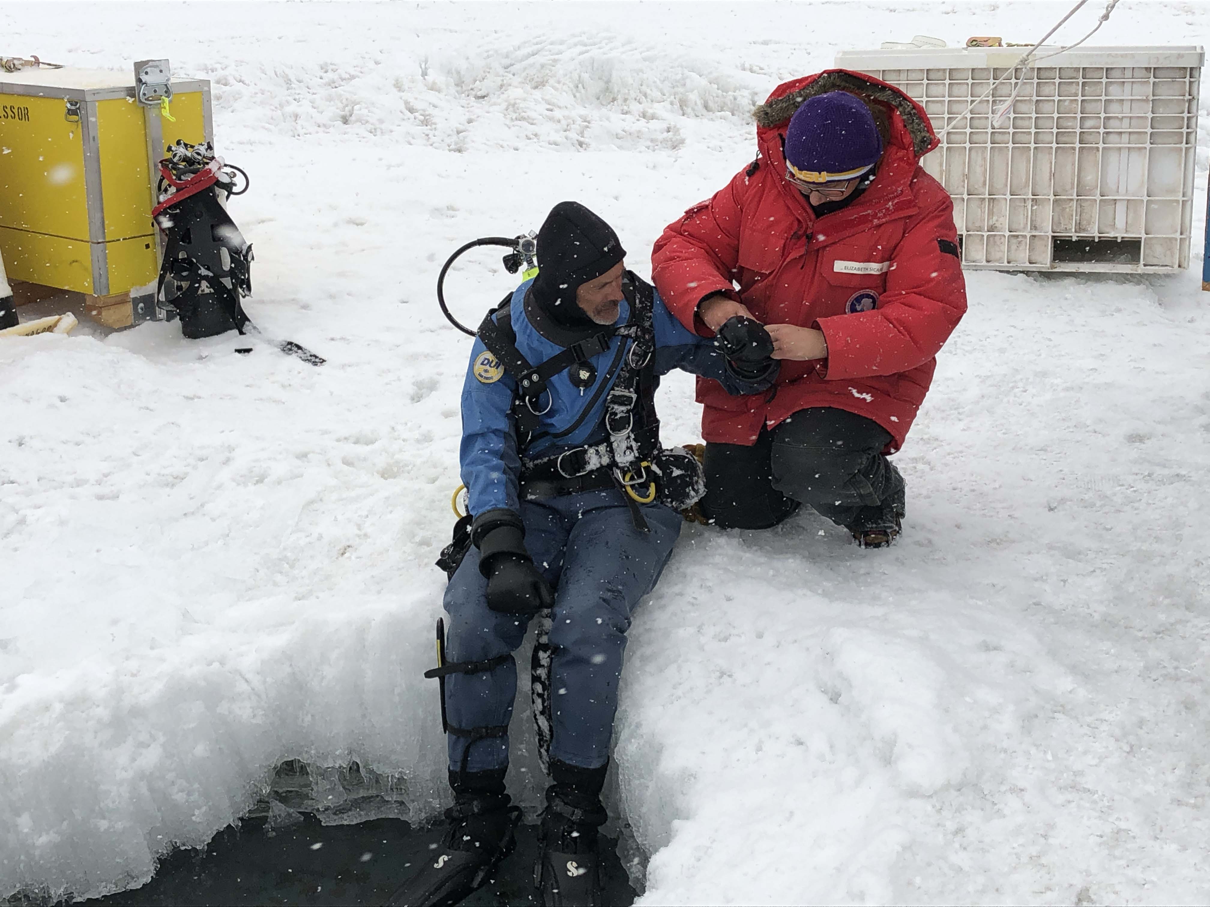 A photo of LSU Geology & Geophysics researchers suiting up to dive beneath the Antarctic ice.